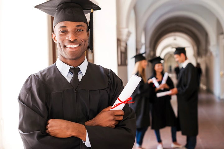 college graduate holding his diploma | Salina Subaru in Salina KS